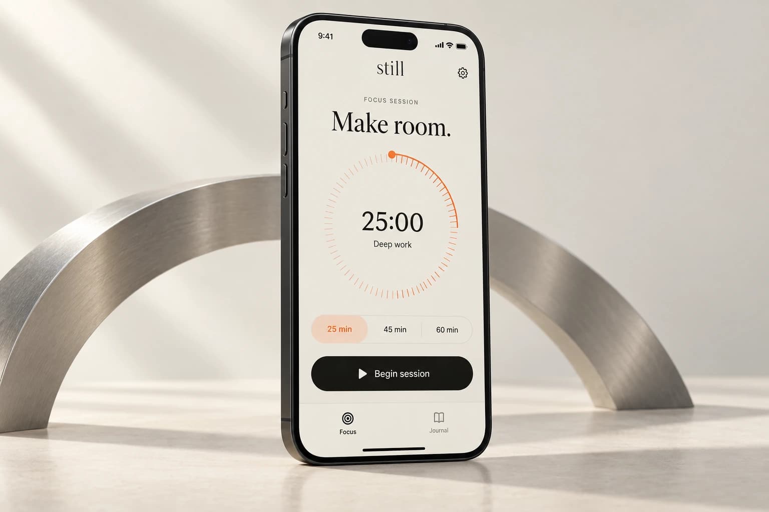 Still focus app concept with an ivory interface, orange timer dial, and a Begin session control on an iPhone beside a silver arc